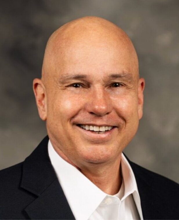 Smiling bald man in suit