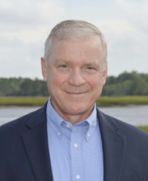 Smiling middle-aged man in jacket outdoors